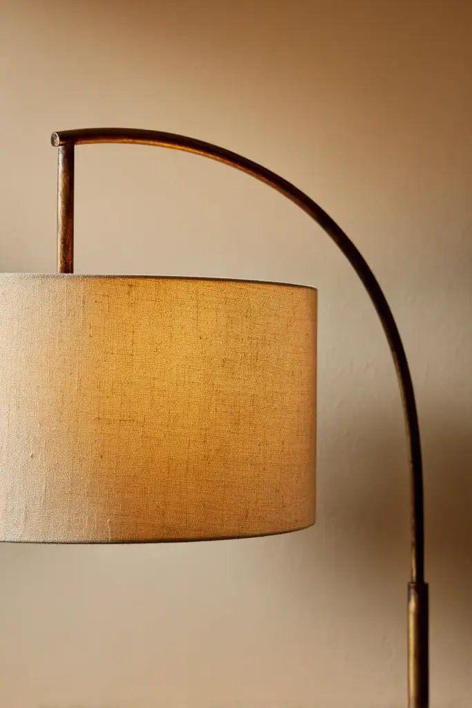 Brass Arc Lamp Against Neutral Backdrop